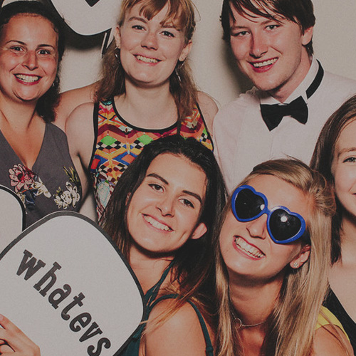 Photo of students using a photobooth with props